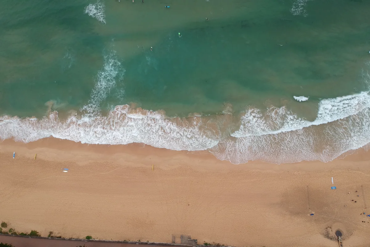 Aerial view of waves reaching the sand at Manly Beach